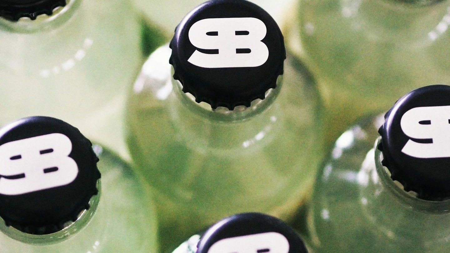 A close up of a bunch of green soda bottles